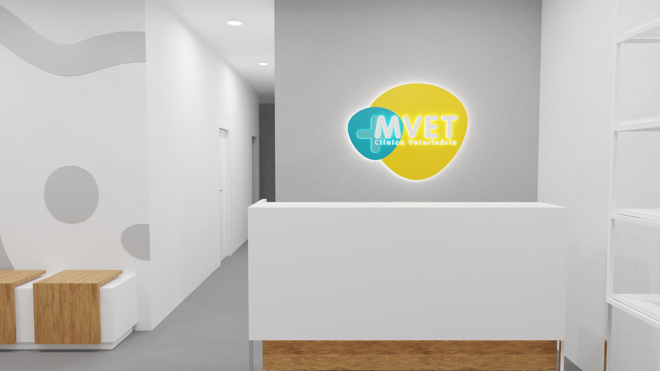 Receção e corredor da MVET, com balcão branco comprido, logótipo iluminado ao centro e silhuetas de animais aplicadas na parede lateral.