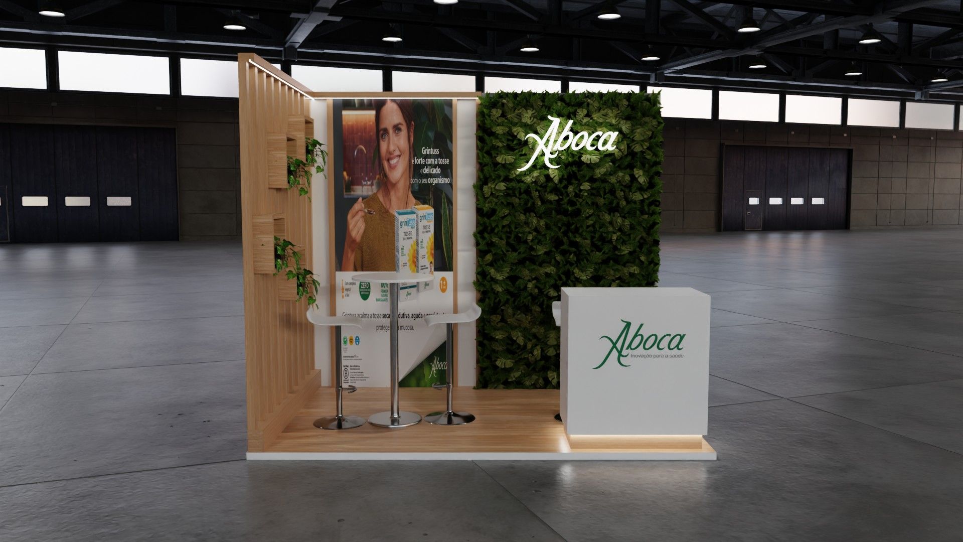 Stand Aboca de frente, com cartaz de produto ao centro, jardim vertical com o logótipo à direita e mesa alta com bancos.
